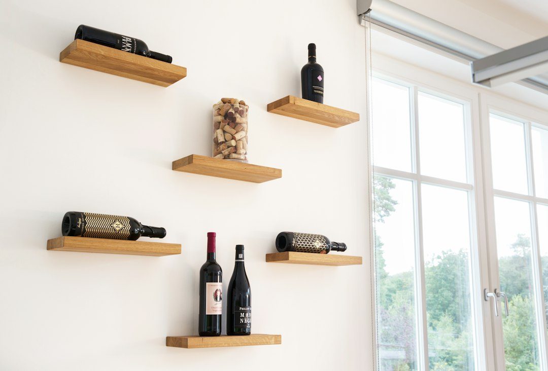A Floating Oak Wine Bottle Shelf With Notched Cradles
